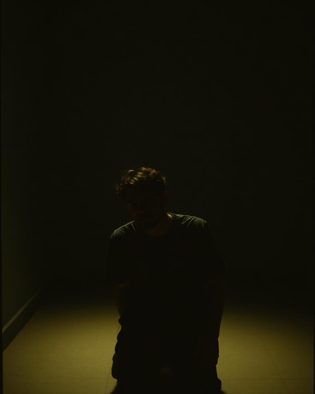 The founder of The Growth Pain in a quiet, low-lit room