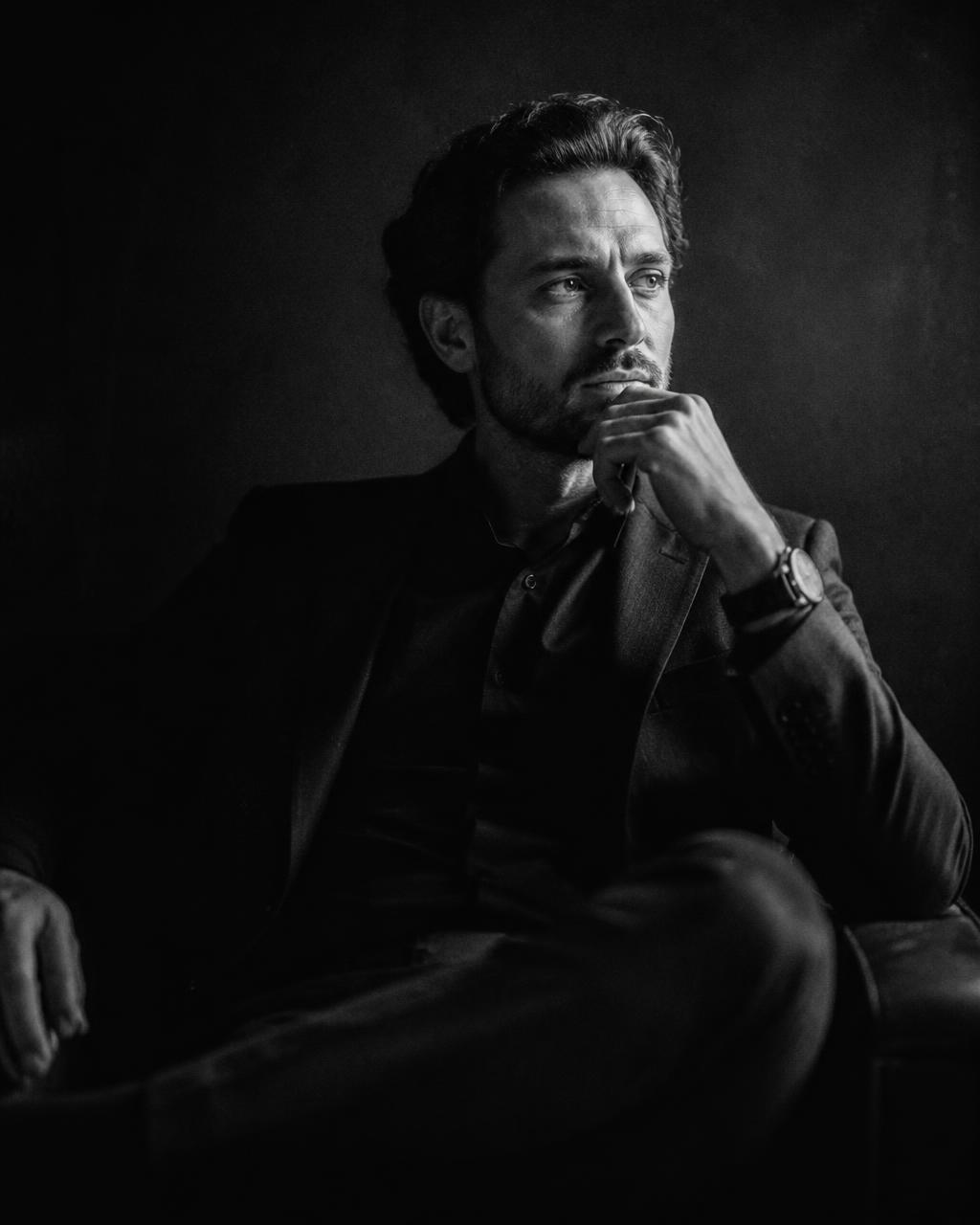 Portrait of a founder in a darkened studio